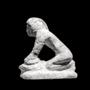 Stone figure of woman making bread